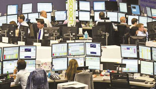 Brokers working on their computers at the Frankfurt Stock Exchange.The DAX 30 ended 0.2% down at 13,208.89 points yesterday.