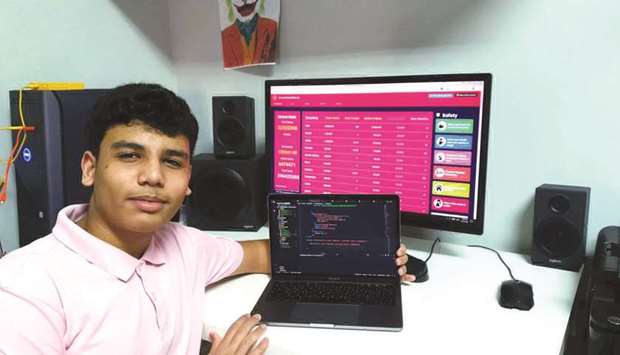 Ahmed Jehad posing with his website in the background.
