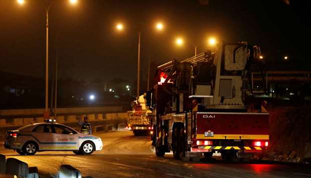 Civil defense vehicles leave for Amman at the highway between Jordanian capital of Amman and the cit