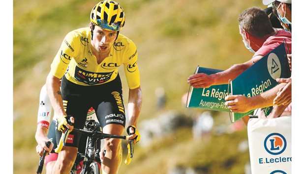 Team Jumbo rider Sloveniau2019s Primoz Roglic, wearing the overall leaderu2019s yellow jersey, and Team UAE Emirates rider Sloveniau2019s Tadej Pogacar (background) arrive at the finish line of the 13th stage of the 107th edition of the Tour de France cycling race, 191km between Chatel-Guyon and Puy Mary, yesterday.