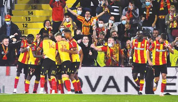 Lensu2019 players celebrate after scoring against Paris Saint-Germain in the Ligue 1 in Lens, northern France, on Thursday night. (AFP)