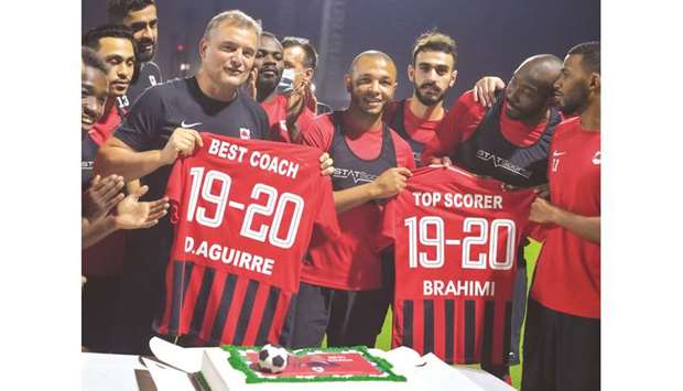 Al Rayyan coach Diego Aguirre (left) and striker Yacine Brahimi, who won the QFA Best Coach and Top Scorer awards respectively, celebrate with the team during a felicitation ceremony.
