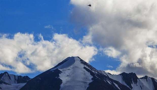 An Indian fighter jet flies over a mountain range in Leh, the joint capital of the union territory of Ladakh