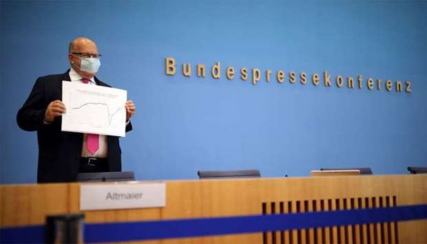 German Economy Minister Peter Altmaier presenting the government's updated economic outlook for 2020 in Berlin on Tuesday. A strong response from the state was helping fuel a quicker-than-expected recovery from the coronavirus shock, Altmaier said.