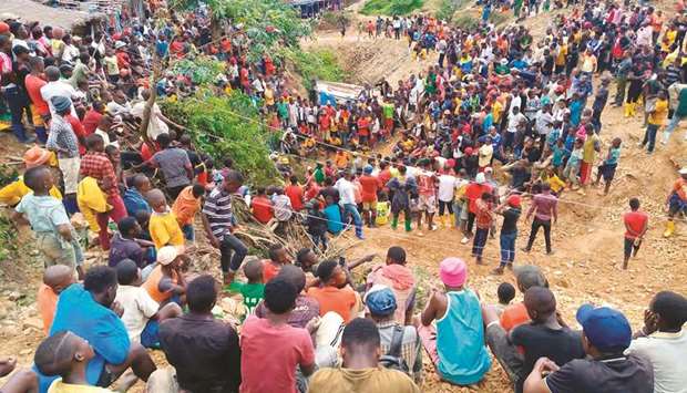 People gather at the entrance of one of the mines in Kamituga, South Kivu, where dozens of artisanal miners are presumed dead after heavy rain filled the mine tunnels.