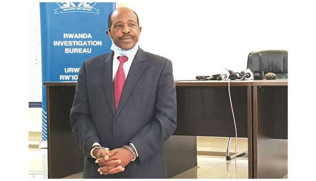 Paul Rusesabagina, the man who was hailed a hero in a Hollywood movie about the countryu2019s 1994 genocide is detained and paraded in front of media in handcuffs at the headquarters of Rwanda Investigation Bureau in Kigali, Rwanda.