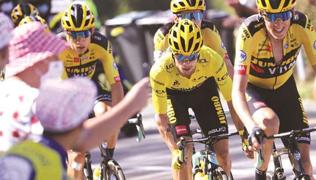 Team Jumbo rider Sloveniau2019s Primoz Roglic wearing the overall leaderu2019s yellow jersey (second from right) rides during the 14th stage of the 107th edition of the Tour de France yesterday. (AFP)