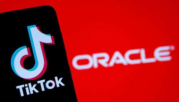 A smartphone with the Tik Tok logo is seen in front of a displayed Oracle logo in this illustration taken on Monday. Oracle beat Microsoft in the battle for the US arm of TikTok with a deal structured as a partnership rather than an outright sale to try to navigate geopolitical tensions between Beijing and Washington, people familiar with the matter have said.
