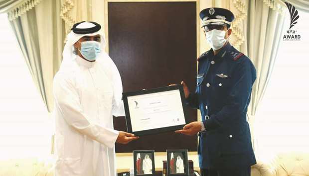 HE Director of Public Security Major General Saad bin Jassim al-Khulaifi receives the Football For All Award on behalf of the Ministry of Interior from General Secretary of the Board of Trustees of QFA Award Hassan Rabiah al-Kuwari.