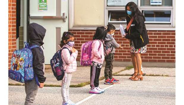 Students arrive for the first time since the start of the coronavirus disease at Hunteru2019s Glen Junior Public School, part of the Toronto District School Board (TDSB) in Scarborough, Ontario, Canada, yesterday.
