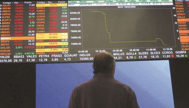 A man stands in front of an electronic display at B3 Brazilian Stock Exchange in Sao Paulo (file).