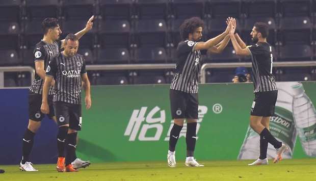 Al Saddu2019s Akram Afif (second from right) is congratulated by teammates Baghdad Bounedjah (left), Santi Cazorla (second from left) and Hassan al-Haydos after he scored a goal during the AFC Champions League Group D match against Al Ain yesterday. PICTURE: Noushad Thekkayil