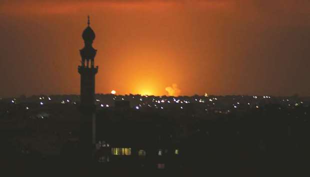 Smoke and flames are seen following an Israeli air strike in the Khan Yunis town of the southern Gaza Strip yesterday.