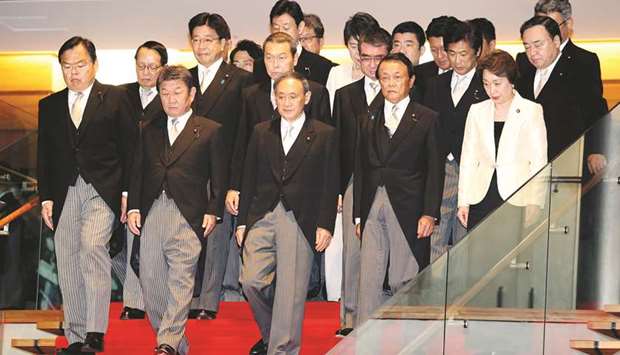 Newly-appointed Japanese Prime Minister Yoshihide Suga leads his cabinet members to a photo session at the prime ministeru2019s official residence in Tokyo yesterday.