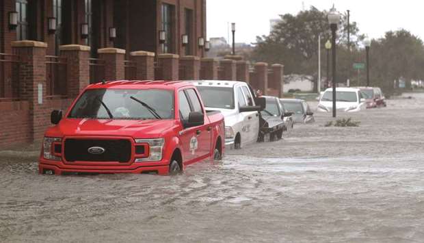Vehicles are seen in a flooded street as Hurricane Sally passes through Pensacola, Florida, yesterday.