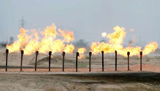 Flames are seen at a station in Al-Zubair oilfield, near Basra (file). Iraq is exporting more crude so far in September than it shipped last month, a sign that the country is falling further behind in efforts to comply with its Opec+ production limit.