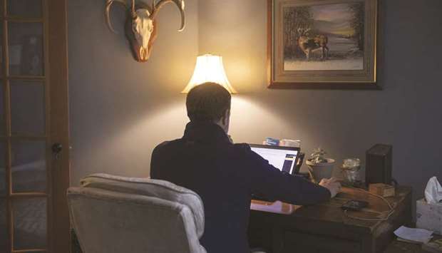 A person works from home on a laptop computer in Princeton, Illinois. A Wells Fargo/Gallup survey released yesterday found 42% of 1,094 workers surveyed in August had a positive view of working remotely, versus 14% who viewed it negatively.
