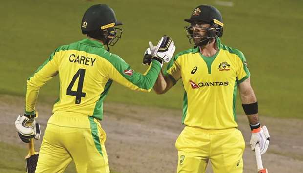Australiau2019s Glenn Maxwell (right) celebrates his century with Alex Carey during the third ODI against Australia in Manchester yesterday. (Reuters)
