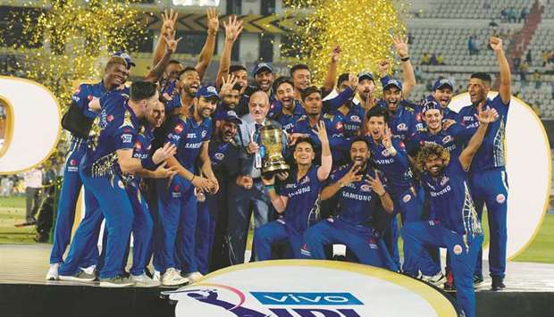 The victorious Mumbai Indians team with the IPL trophy after winning the tournament in 2019.