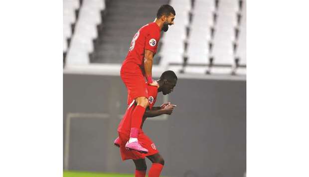 Al Duhailu2019s Ramin Rezaeian (top) celebrates a goal with teammate Almoez Ali during the AFC Champions League Group C match against Sharjah on Tuesday. PICTURE: Noushad Thekkayil