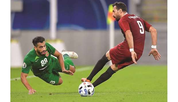 Majed Hassan (left) of Shabab Al Ahli and Shahr Khodrou2019s Amin Ghaseminejad vie for the ball during their AFC Champions League Group B match at Al Janoub Stadium yesterday. PICTURE: Noushad Thekkayil