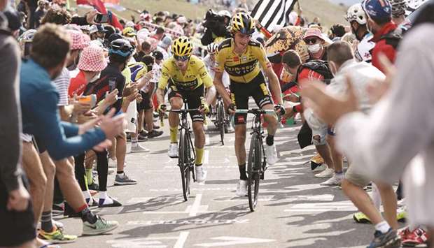 Team Jumbo rider Sloveniau2019s Primoz Roglic (left) wearing the overall leaderu2019s yellow jersey and Team Jumbo rider USu2019 Sepp Kuss ride in the Loze pass during the 17th stage of the 107th edition of the Tour de France yesterday. (AFP)