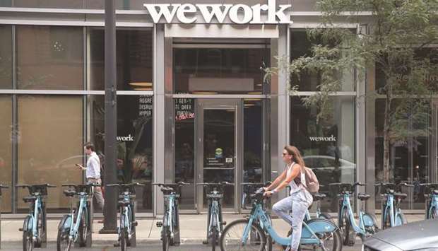 A sign marks the location of a WeWork office facility in Chicago. As future-of-work discussions shift from theoretical to practical, one much-maligned company that could be a solution to a world of hybrid work is WeWork.