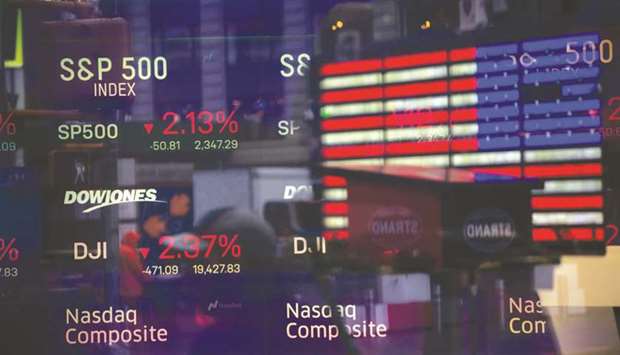 Monitors displaying stock market information are seen through the window of the Nasdaq MarketSite in New York. In one of their few prescient moves of 2020, hedge funds backed off from the summeru2019s hottest trade and went bargain hunting, just in time for a revival in value stocks.