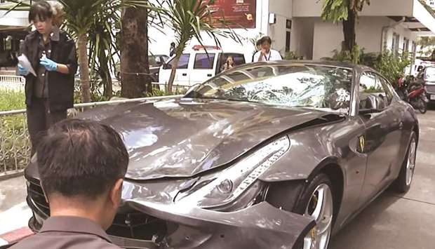 In this file photo frame grab from video footage shows police inspecting the Ferrari car belonging to Red Bull heir Vorayuth u201cBossu201d Yoovidhya in Bangkok, after a hit-and-run case which resulted in the death of a police officer.