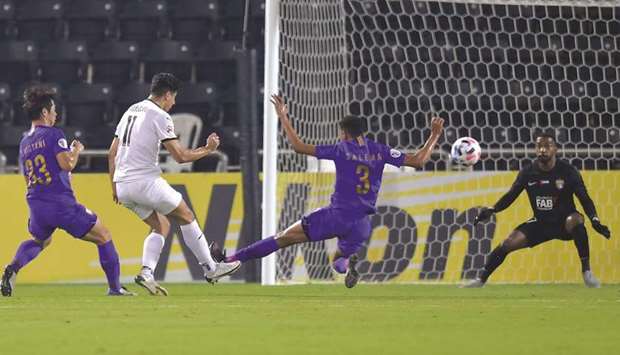 Al Saddu2019s Baghdad Bounedjah (left) scores during the AFC Champions League Group D match against Al Ain at Jassim Bin Hamad Stadium yesterday. PICTURES: Noushad Thekkayil