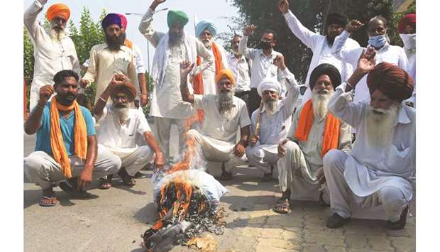Farmers burn an effigy of Prime Minister Narendra Modi in Amritsar yesterday following the passing of agriculture bills in the Lok Sabha.