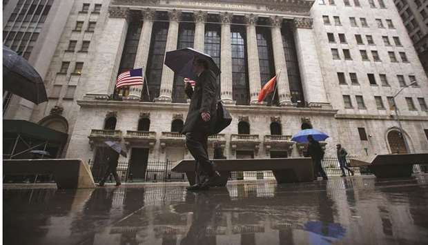Pedestrians walk past the New York Stock Exchange. Investors are gearing up for the yearu2019s record-breaking pace of corporate bond issuance to continue in the coming week, even after the US Federal Reserve rattled nerves at its September meeting with a gloomier-than-expected economic outlook.
