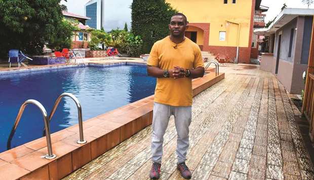 Eric Moussambani standing next to a 12m long small swimming pool, very similar to the small one he used to train in 20 years ago while preparing for the Olympics, at the CHN Flat-Hotel in Malabo on September 12, 2020. (AFP)