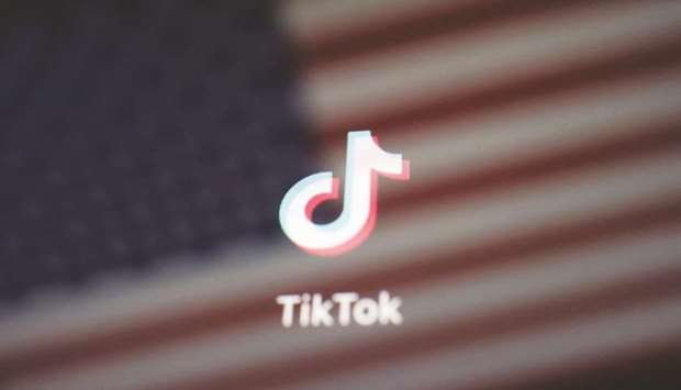 A reflection of the US flag is seen on the sign of the TikTok app in this illustration picture taken on Saturday. Chinau2019s ByteDance is seeking a valuation of $60bn for TikTok as Oracle Corp and Walmart Inc take stakes in the short-video appu2019s business to address US security concerns, according to a person familiar with the matter.