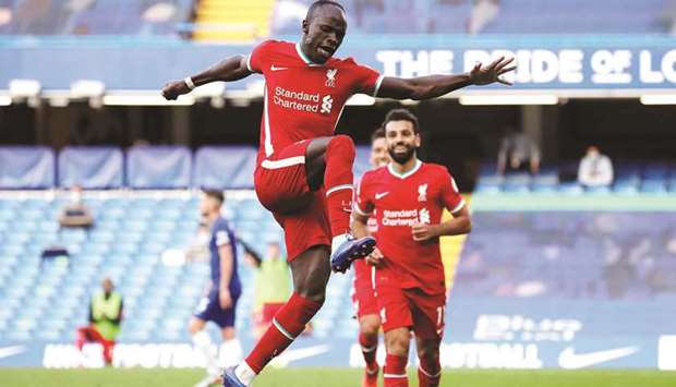 Liverpoolu2019s Sadio Mane (left) celebrates scoring their second goal against Chelsea during their Premier League match in London yesterday. (Reuters)