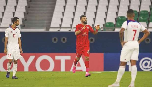 Al Duhailu2019s Ramin Rezaeian (centre) celebrates after scoring during the AFC Champions League Group C match against UAEu2019s Sharjah at the Education City Stadium on Tuesday. (AFP)