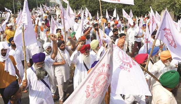 Farmers shout slogans as they stage a protest following the passing of agriculture bills, on the outskirts of Amritsar in Punjab yesterday.