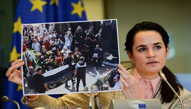 Belarusian opposition leader Sviatlana Tsikhanouskaya holds a picture as she speaks to the members of the European Parliament's Foreign Affairs committee, at the EU Parliament in Brussels, Belgium
