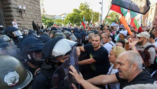 Protesters clash with police officers during an anti-government demo in Sofia