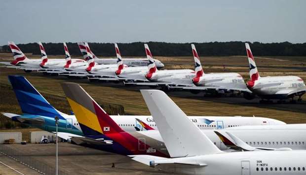 A fleet of Airbus SE A380 passenger aircraft, operated by British Airways, sit parked near other grounded jets at Chateauroux airport in France. Airlines worldwide have been largely grounded since mid-March. Air travel has fallen on hard times since the onset of the pandemic six months ago, with the number of travellers dropping significantly.