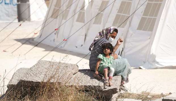 A woman and her child are seen at the new temporary camp for migrants and refugees, on the island of Lesbos, Greece.