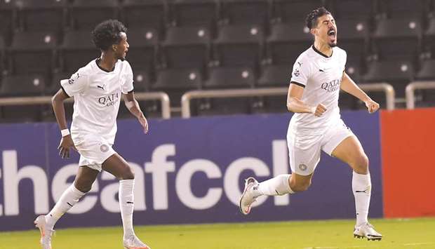 Al Saddu2019s Baghdad Bounedjah (right) celebrates his goal during the AFC Champions League Group D match against Al Nassr at Jassim Bin Hamad Stadium yesterday. PICTURE: Noushad Thekkayil