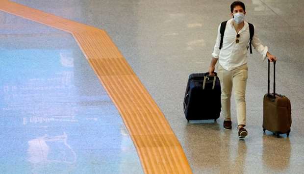 A passenger wearing a protective face mask walks at Fiumicino Airport In Rome, Italy. File picture: May 28, 2020