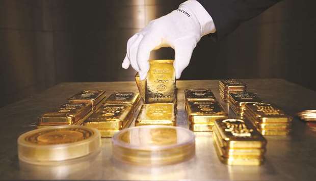 Gold bars and coins are stacked in the safe deposit boxes room of the Pro Aurum gold house in Munich (file). Gold has been on a record-setting tear as the pandemic threatens to derail global economic growth, sending investors on a flight to safe havens.