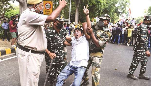 A member of the Youth Congress is detained by police during a protest against the passing of new farm bills, in New Delhi yesterday.