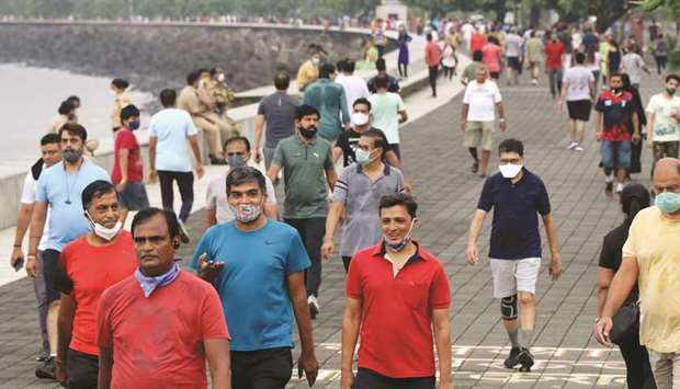 People stroll along the promenade at Marine Drive in Mumbai yesterday. India with 5.6mn cases reported 75,083 new infections in the last 24 hours, and 1,053 deaths over the same period. Maharashtra continues to be the worst-hit state followed by Andhra Pradesh, Tamil Nadu, Karnataka and Uttar Pradesh.