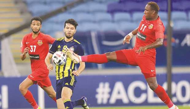 Shabab Al Ahli (in red) played out a draw with Pakhtakor (in blue and yellow) on Sunday. PICTURE: Noushad Thekkayil