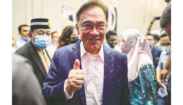 Malaysian politician Anwar Ibrahim gives a thumbs up after a press conference at a hotel in Kuala Lumpur, yesterday.