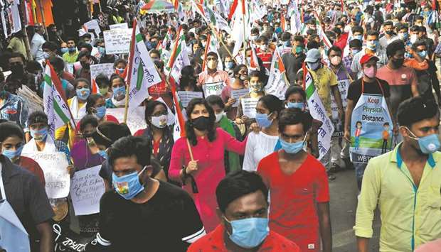 Demonstrators carry placards and banners as they attend a protest march against farm bills passed by parliament, in Kolkata yesterday.