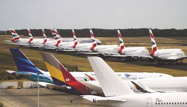 A fleet of Airbus A380 passenger aircraft, operated by British Airways, sit parked near other grounded jets at Chateauroux airport in Chateauroux, France. Globally, airlines are expected to lose $84.3bn this year as airlines worldwide have been largely grounded since mid-March.